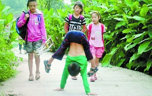 倒立行走去上學(xué) 堅強癱瘓男孩感動網(wǎng)友。圖據(jù)山東商報